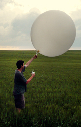 Dr. Matt Parker launches a weather balloon with attached sensors.