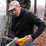 Dr. Ted Simons checks the batteries for the transmitter that sends eaglecam pictures across Jordan Lake.