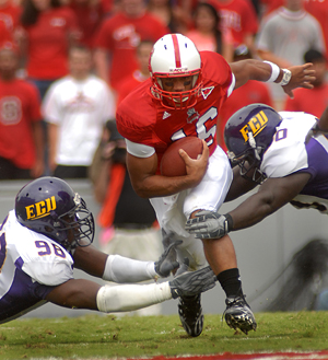 Quarerback Russell Wilson tucks and runs against ECU. PHOTO BY ROGER WINSTEAD