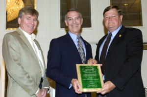Jack Colby, right, and David Hatch, left, accept award honoring NC State for sustainability efforts.