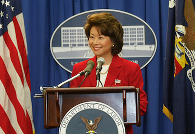 As Secretary of Labor, Chao announces the resolution of the West Coast Ports dispute.