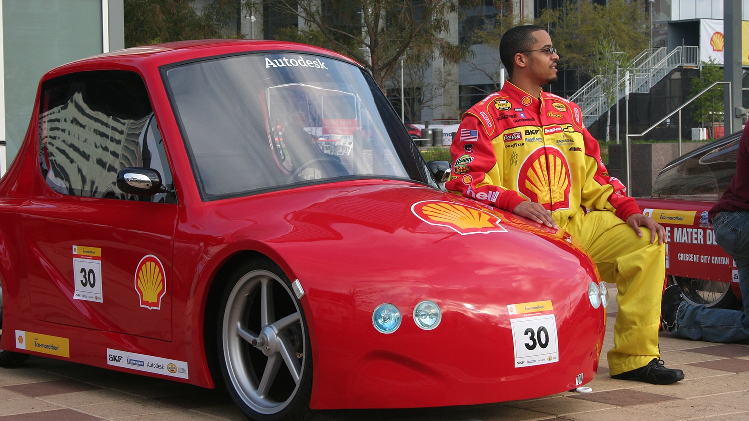 Sean Coleman posing next to his concept car.