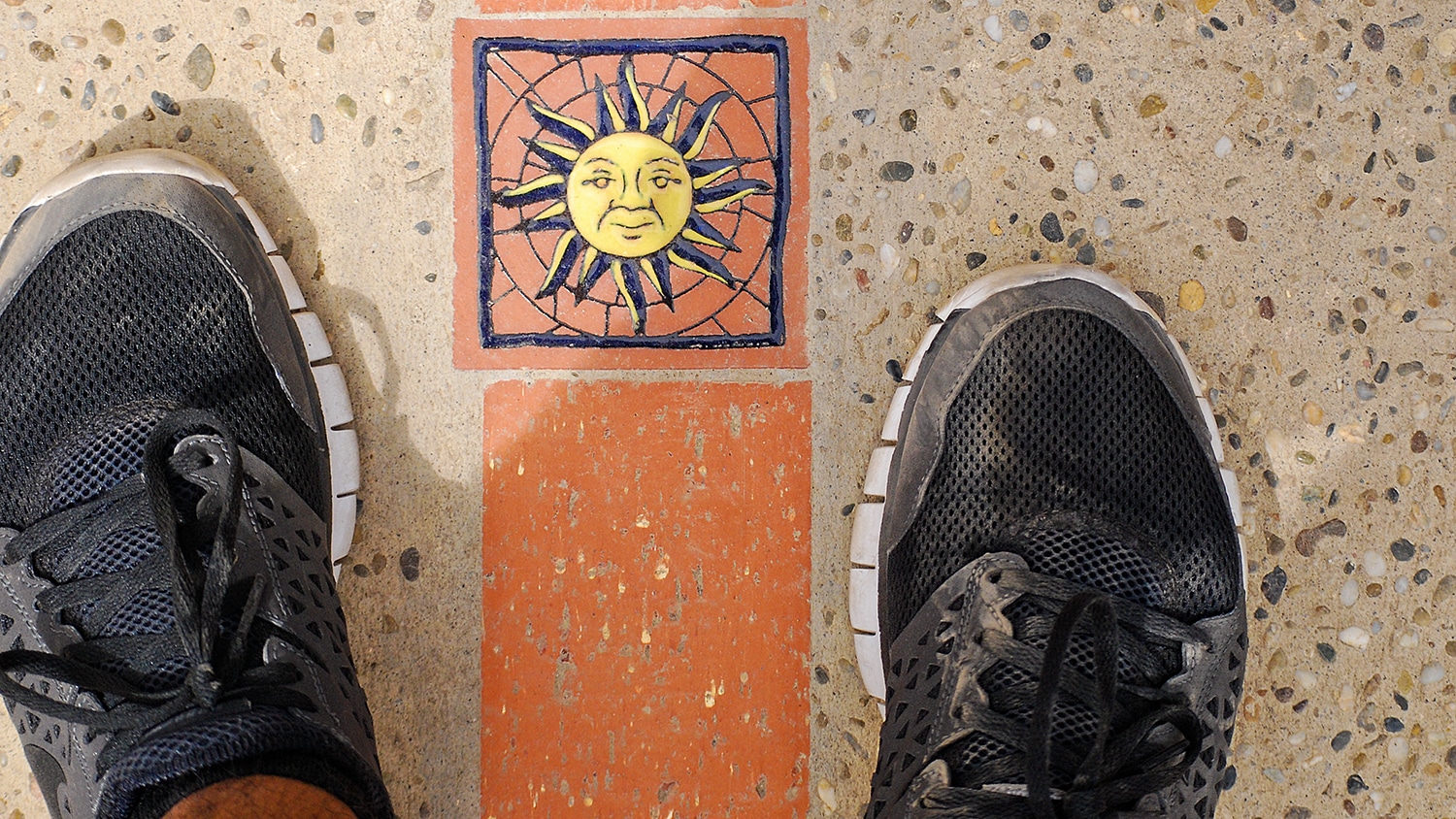 Saul Flores' feet on either side of a line marking the equator.