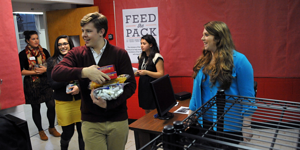 Students bring donations of food to the new food pantry.