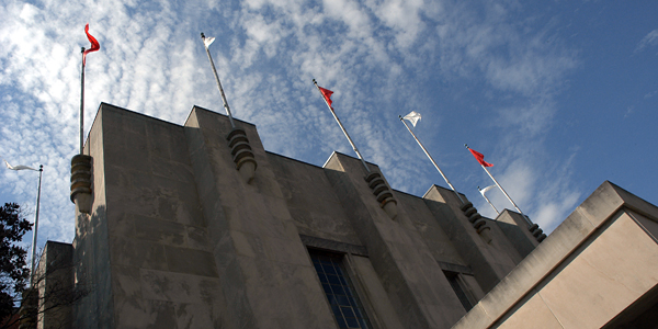 Red and white flags fly atop Reynold Coliseum.