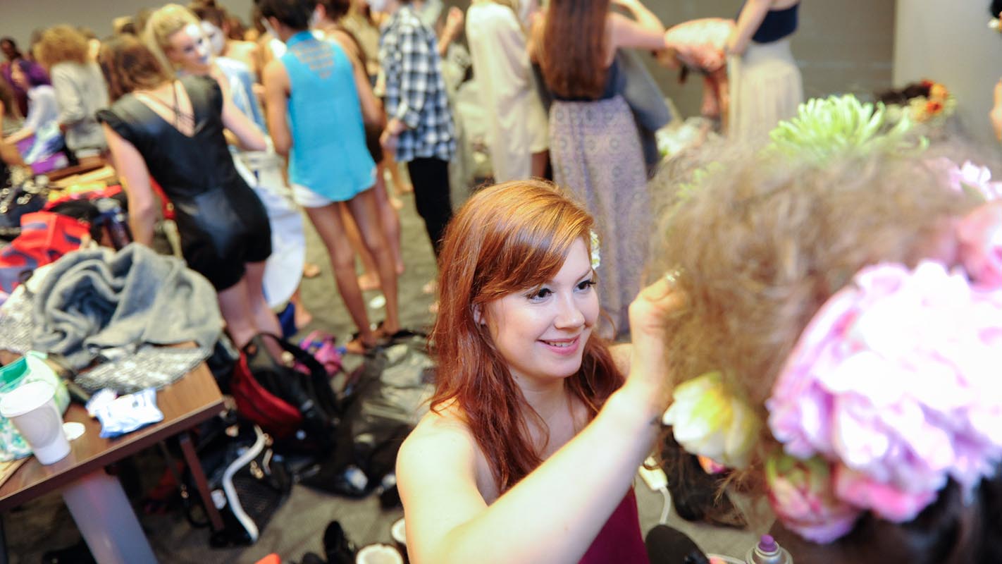 A2W designer Rachel Bridge preps a model before she hits the runway.