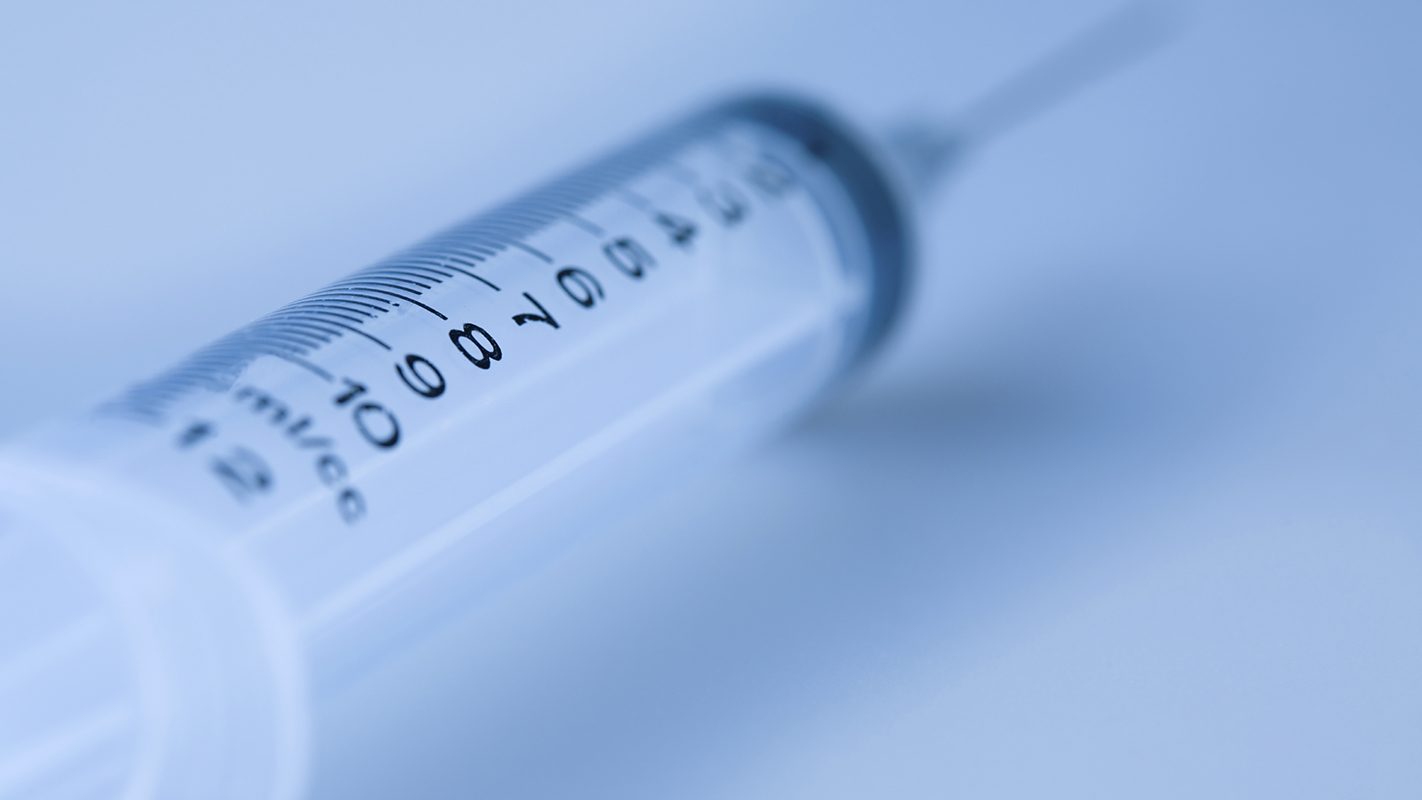 Medical syringe in a blue shade.