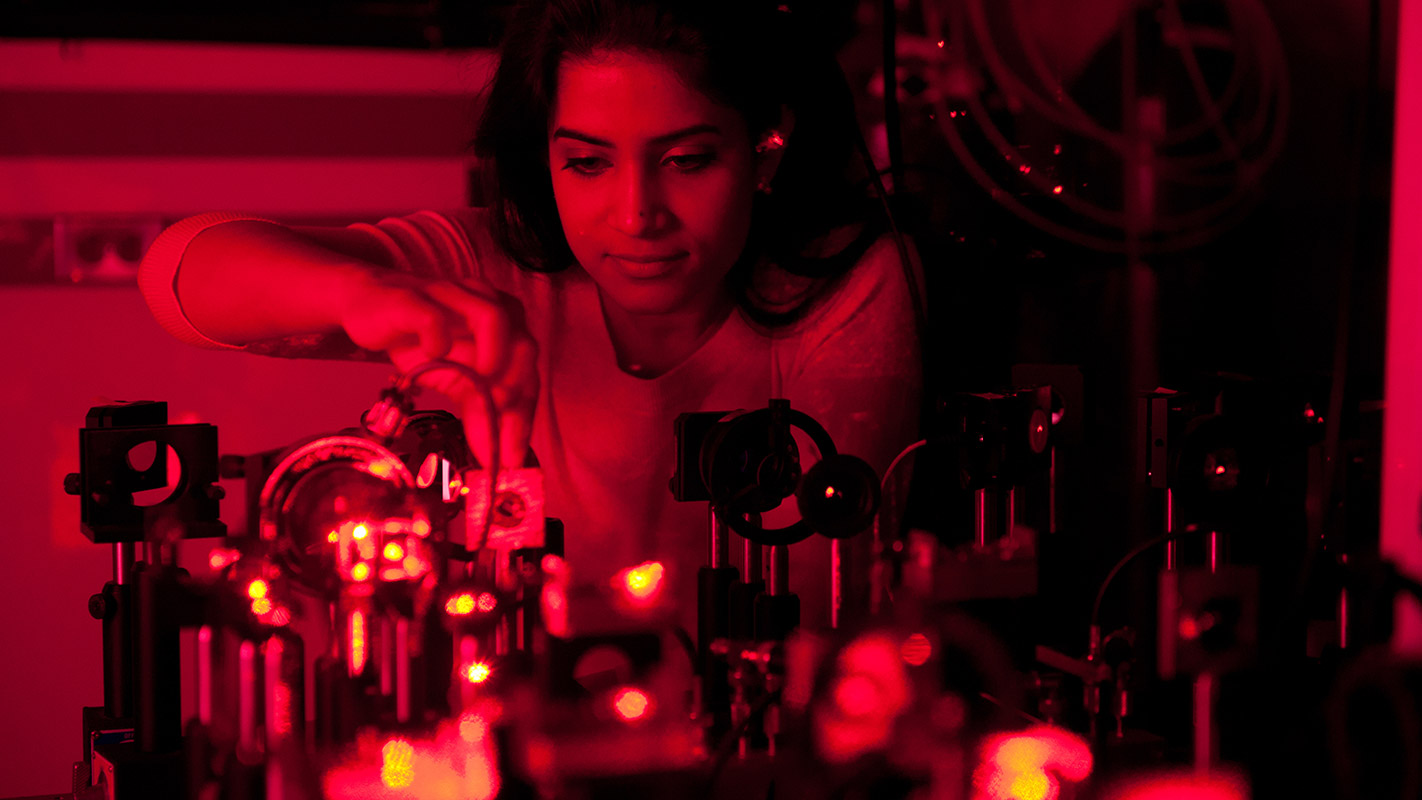 An NC State student is lit red as she works in the JET lab.