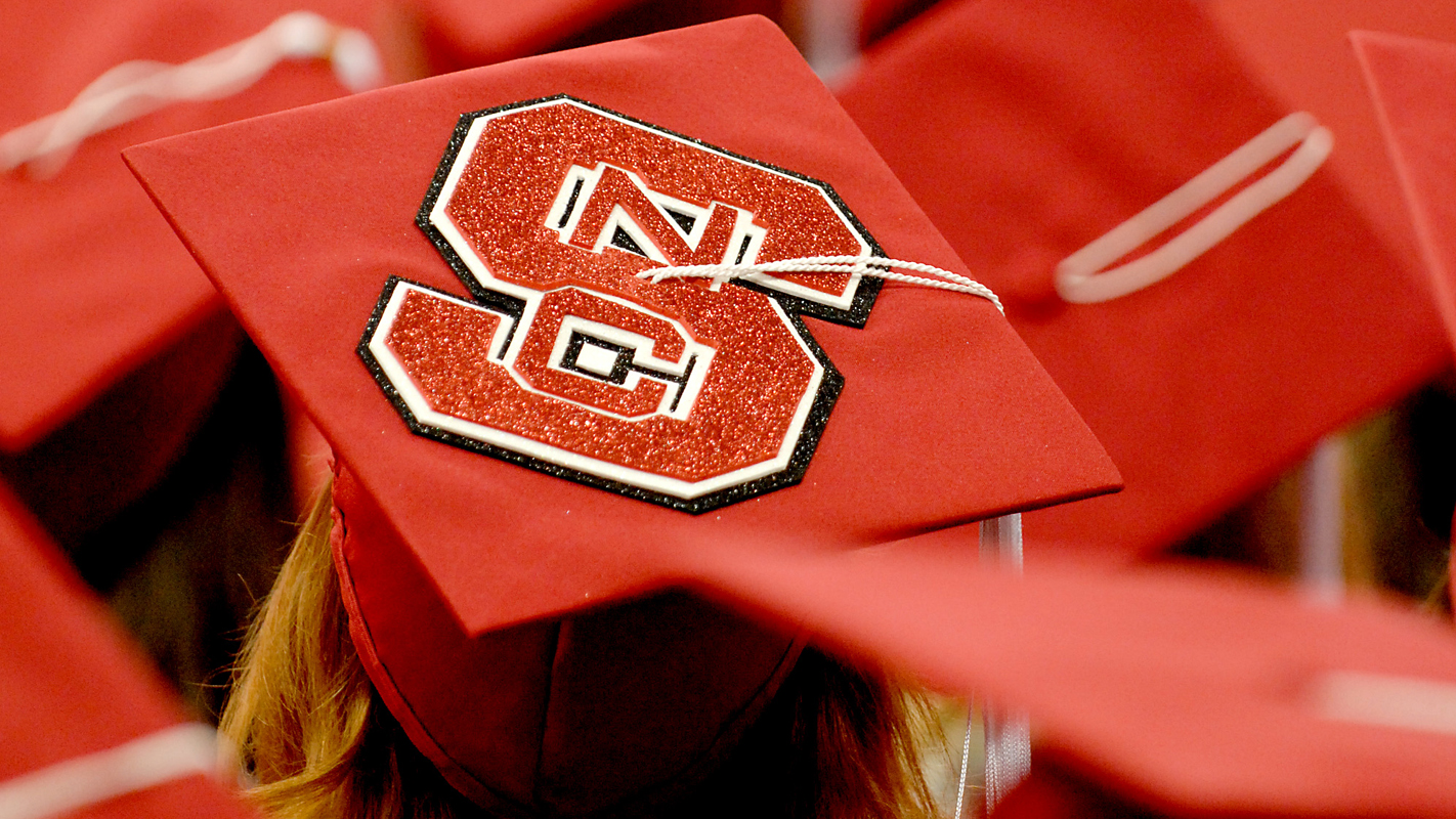 red mortarboard with block S logo