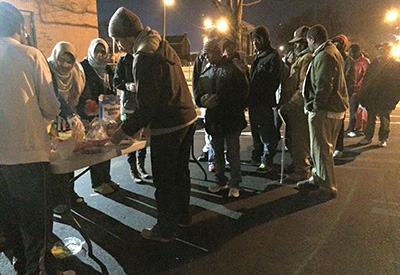 Deah Barakat and Yusor Abu-Salha helping at a homeless outreach project.