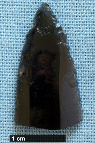 Fragment of an obsidian blade that had been shaped to a point, collected during the survey of Tlaxcallan. Photo Credit: John Millhauser. Click to enlarge.