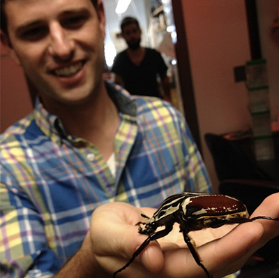 Penick and a really big insect. Photo courtesy of Clint Penick.