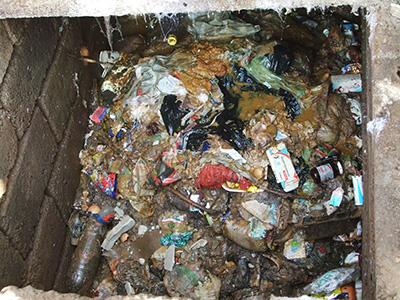 Pit latrines can be filled with solid trash (like this one in South Africa), which can clog the Excrevator. Photo courtesy of Tate Rogers.