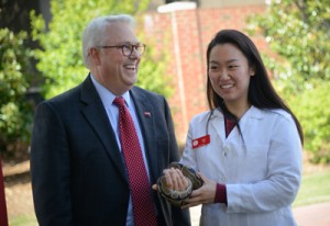 Chancellor Woodson shares a moment with VetMed student Karen Park as Park holds a python.