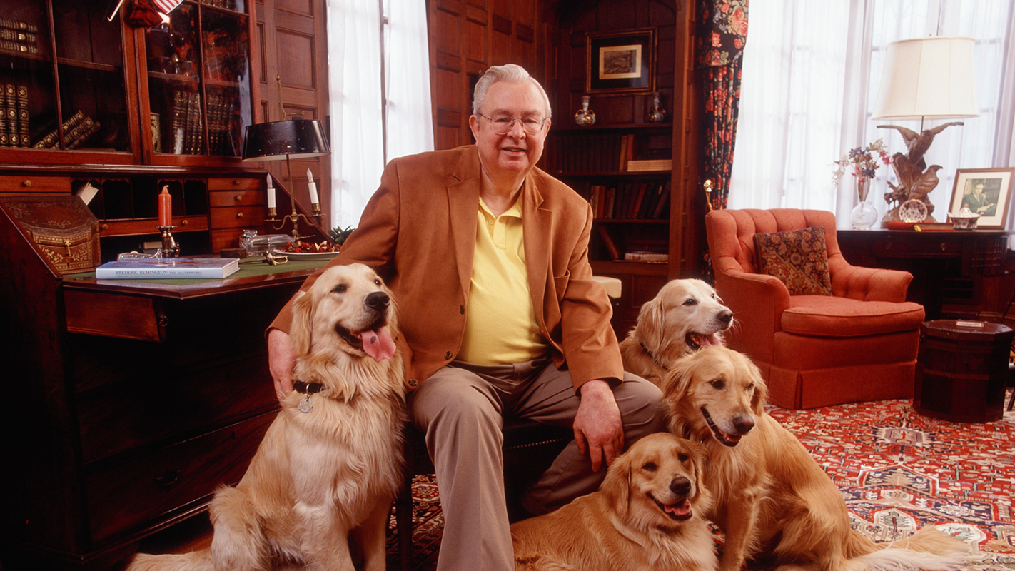 A portrait of the late Randall B. Terry, Jr., surrounded by his cherished golden retrievers.