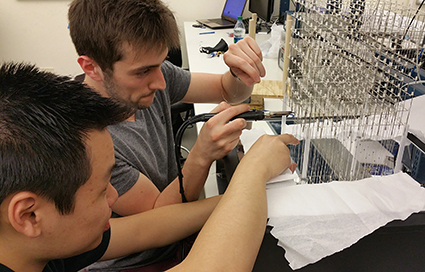 Andy Tong (left) and Robert Jamison work on the cube. Click to enlarge.