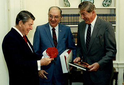 Chancellor Poulton greets important visitors. From left, President Reagan, N.C. Senator Jesse Helms and Poulton.