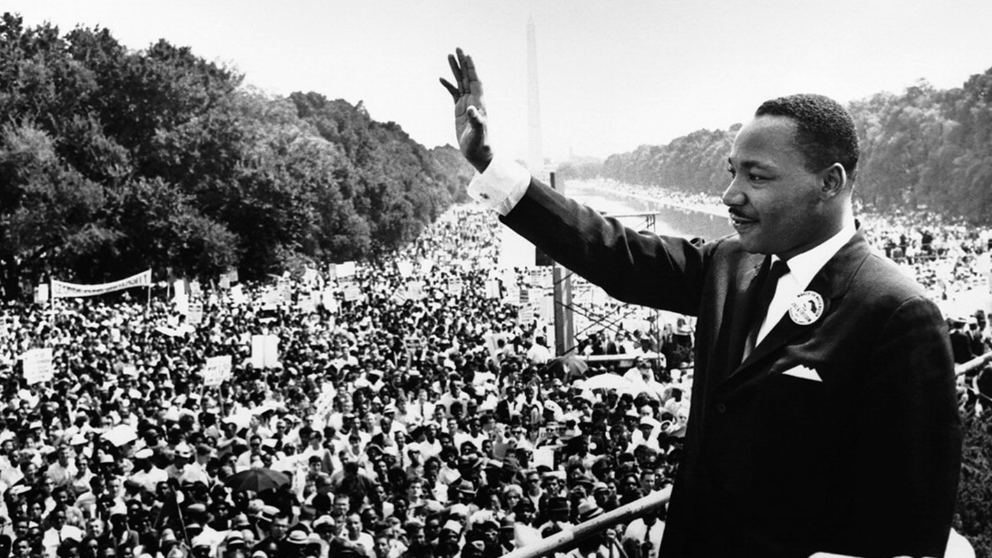 Martin Luther King Jr. waves to a crowd.
