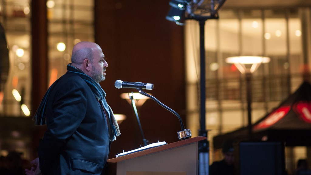 Mohammad Abu-Salha speaks on behalf of the families at a vigil marking the one-year anniversary of the shootings.