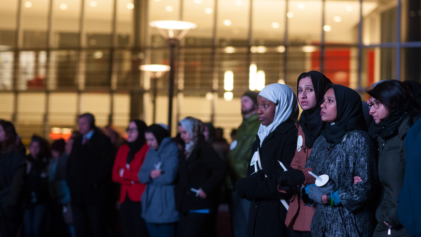 Participants stand arm in arm during the program.