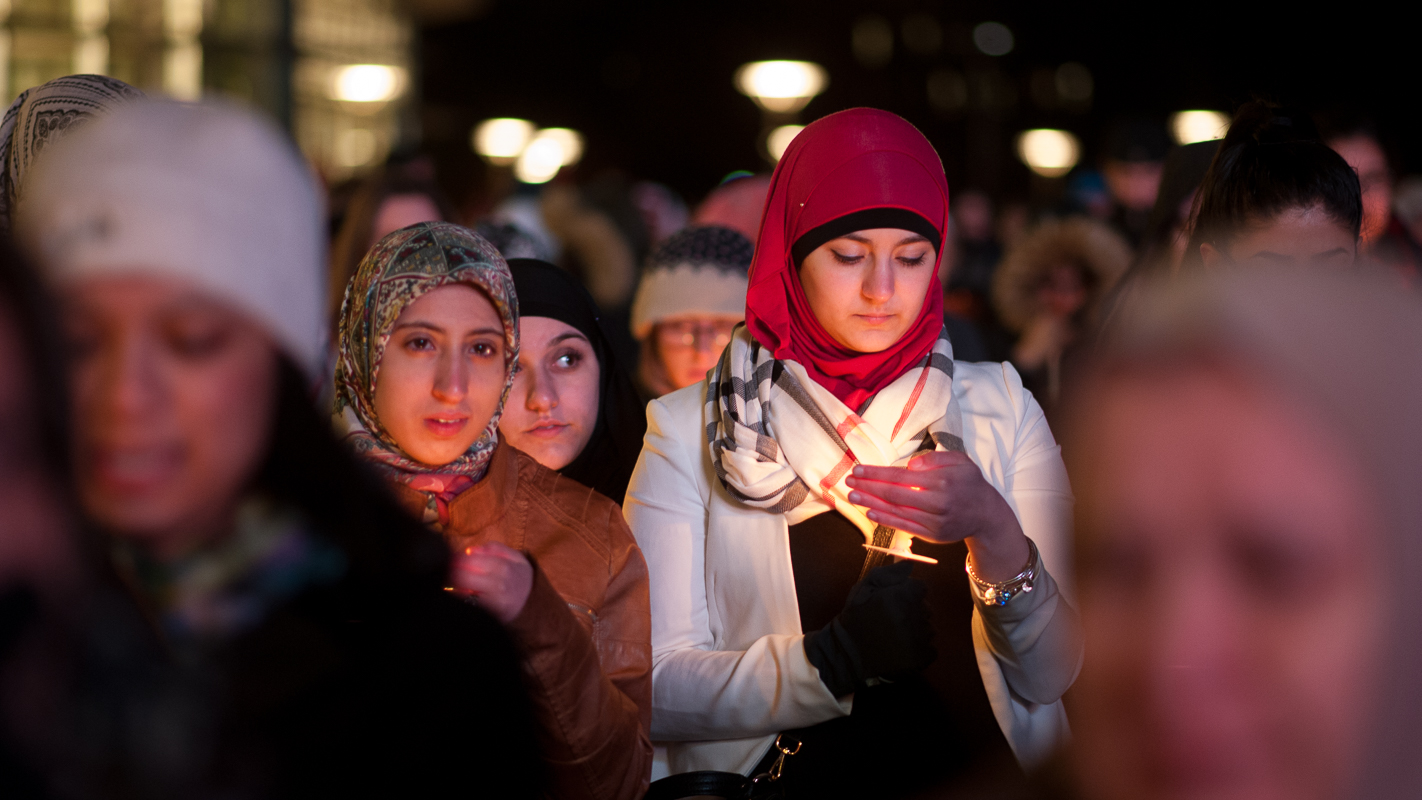 Despite a cold wind, some are able to keep their candles lit.