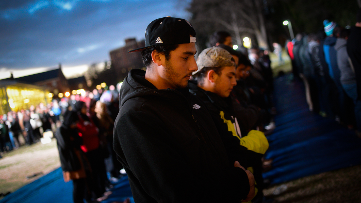 A man participates in the call to prayer at the beginning of the ceremony.