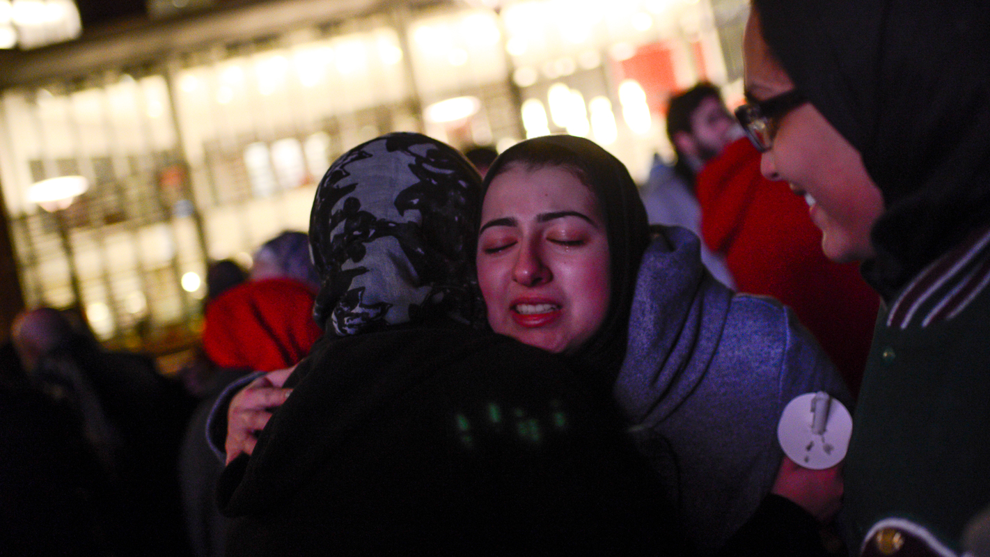 Doha Hindi, a junior, gets a hug after the vigil at Talley.
