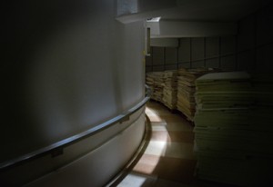 A shaft of light illuminates ceiling ties stacked in the center of Harrelson Hall.