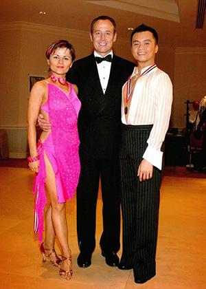 Scott Vu with his partner, Linara Axanova, and coach, Wayne Crowder, after dancing championship latin at Carolina Fall Classic ballroom competition. Photo courtesy of Vu.