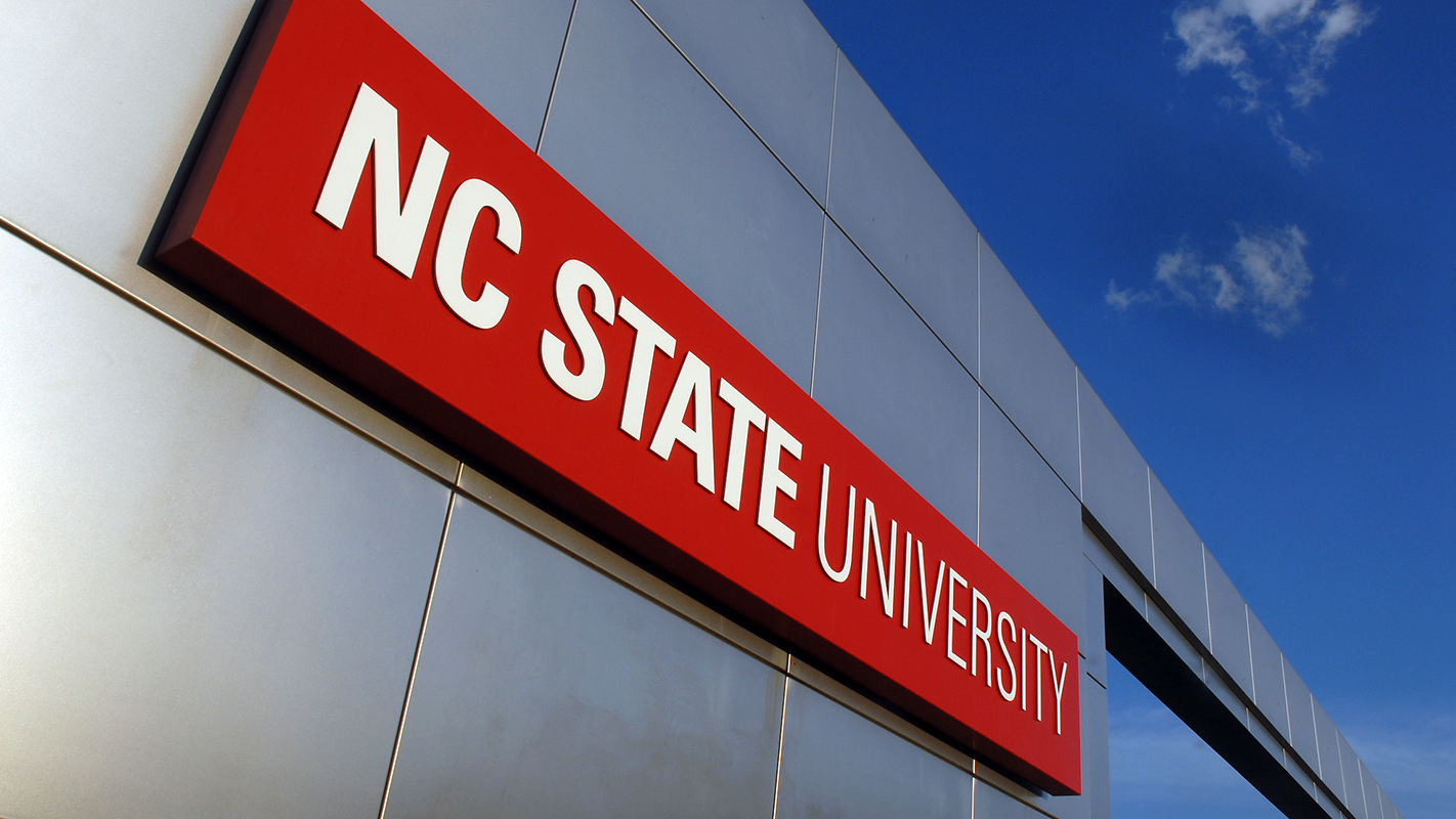 NC State University sign on metal gateway.