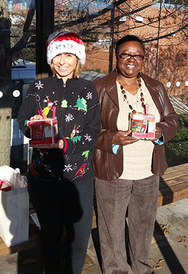 Staff members deliver holiday mugs for Wolfline drivers.