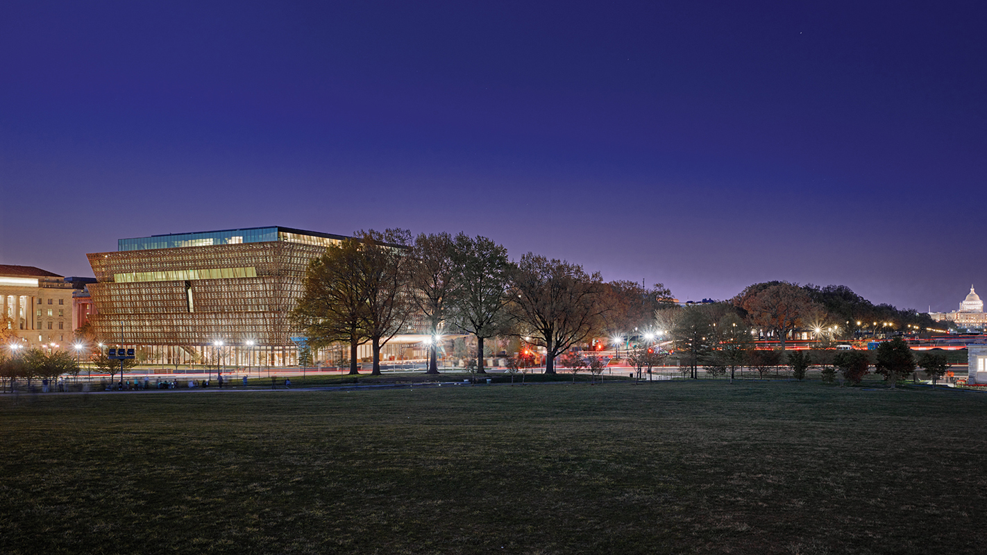 The Smithsonian National Museum of African American History and Culture at night.