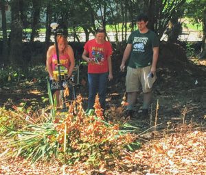 M. Whited guides the GPR unit as N. Womack prepares to help move the GPR unit over a palmetto tree. J. Wall is taking field notes. Credit: D. Bohnenstiehl