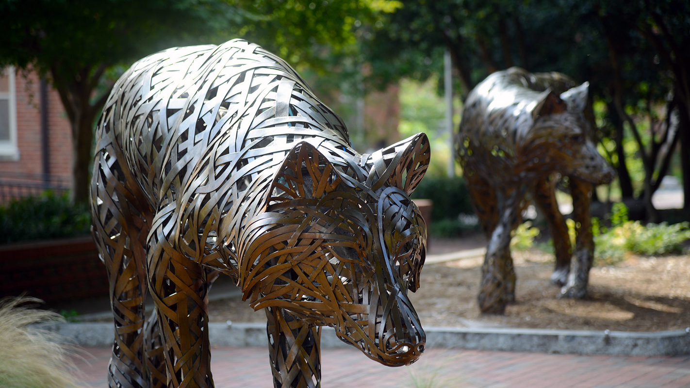 Two of the copper wolves at Wolf Plaza on NC State's campus.