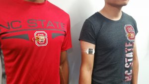 Red and grey NC State T-shirts featuring thermoelectric generators.