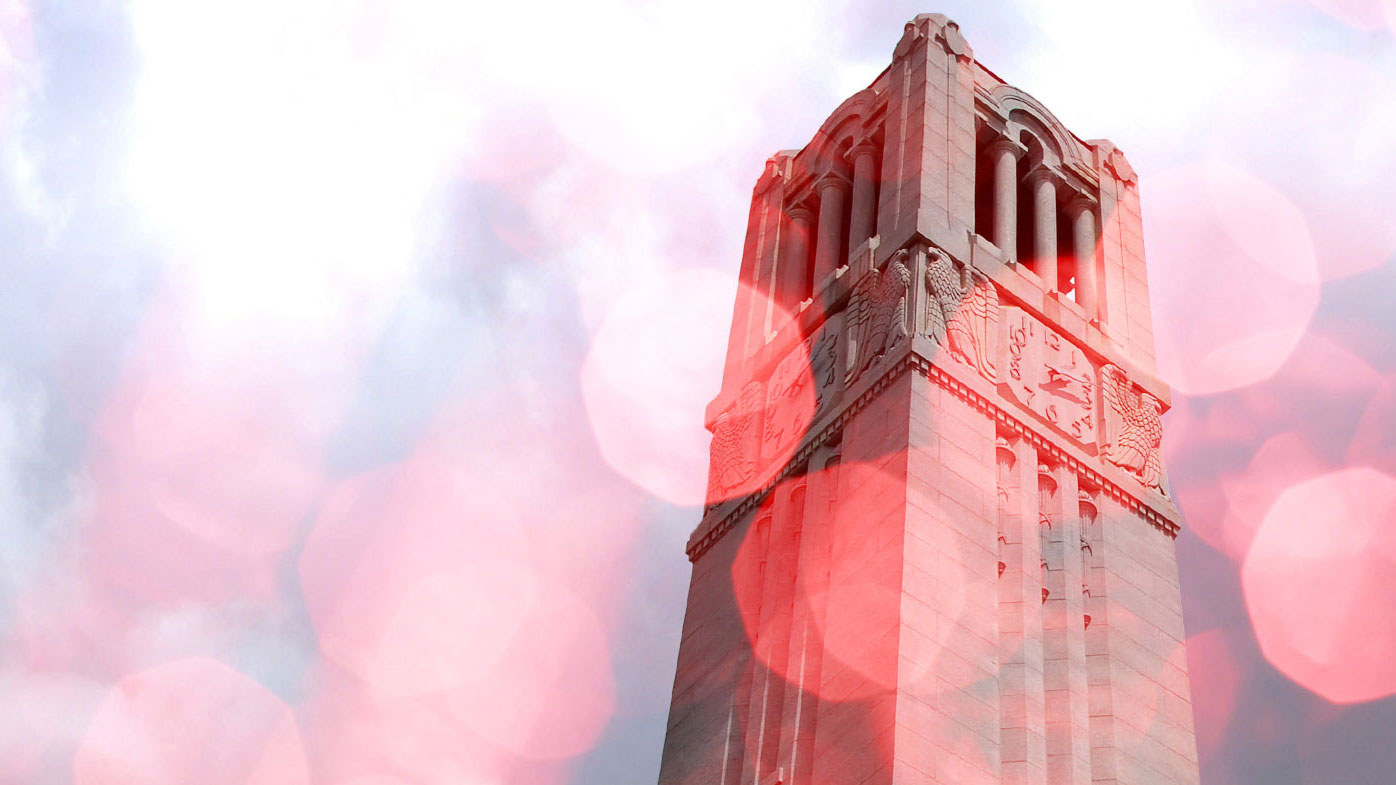 A stylized, rose-tinted NC State Memorial Bell Tower.