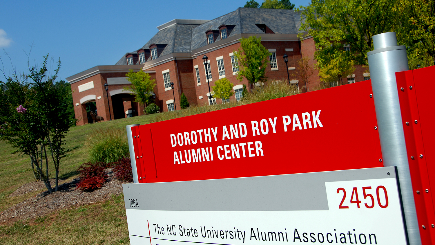 Park Alumni Center, with sign in the foreground.