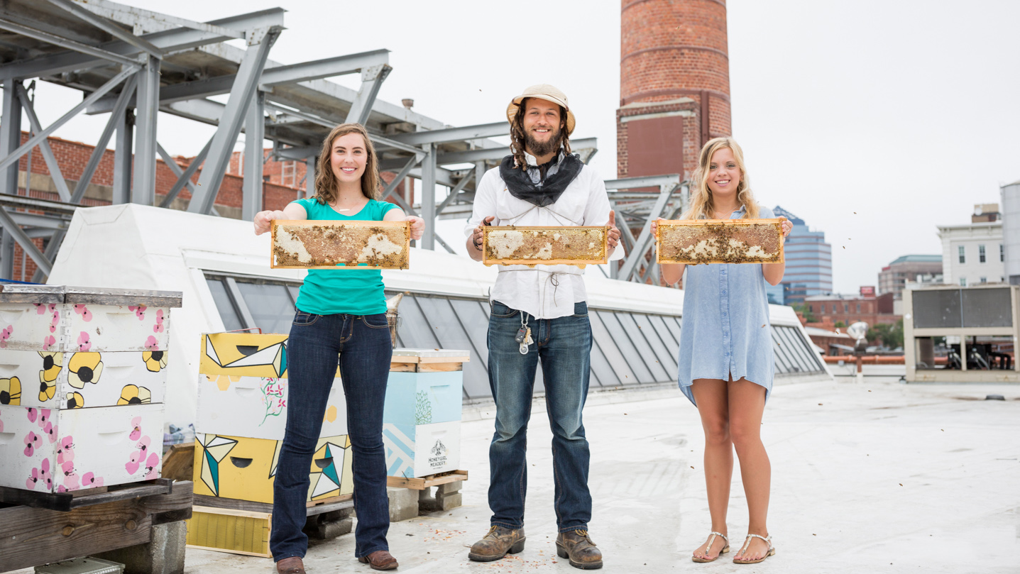 The staff of Bee Downtown poses with bees.