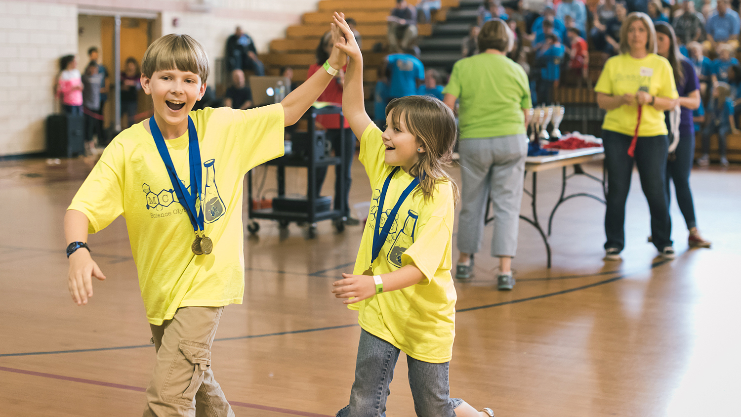 Two Science Olympiad participants high-five