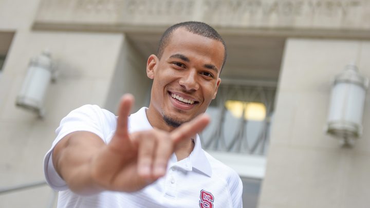 NC State graduate Joshua Gandy throws up the wolf ears.