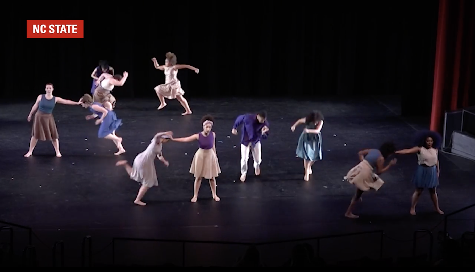 Students with the NC State Dance Program perform on stage.