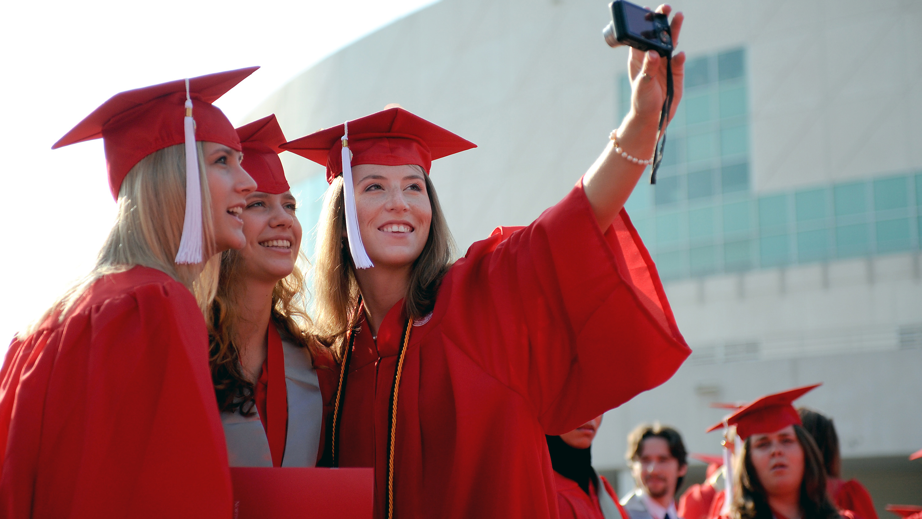 Three NC State graduates pose for a picture