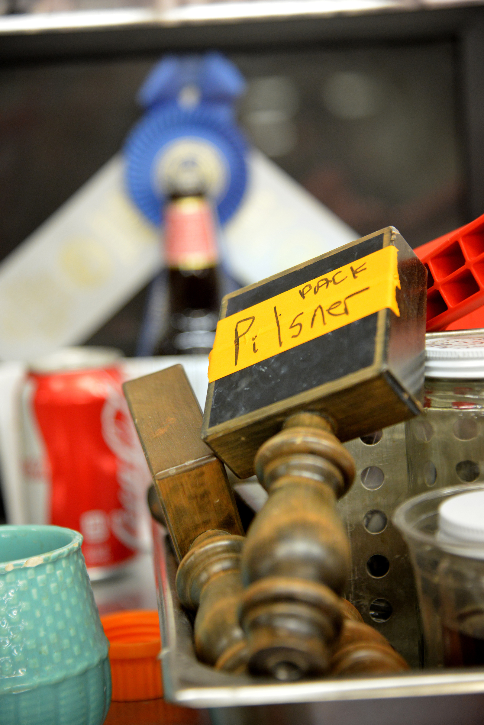 A beer tap handle with a label reading "Pack Pilsner" sits waiting to be used in Schaub Hall. 