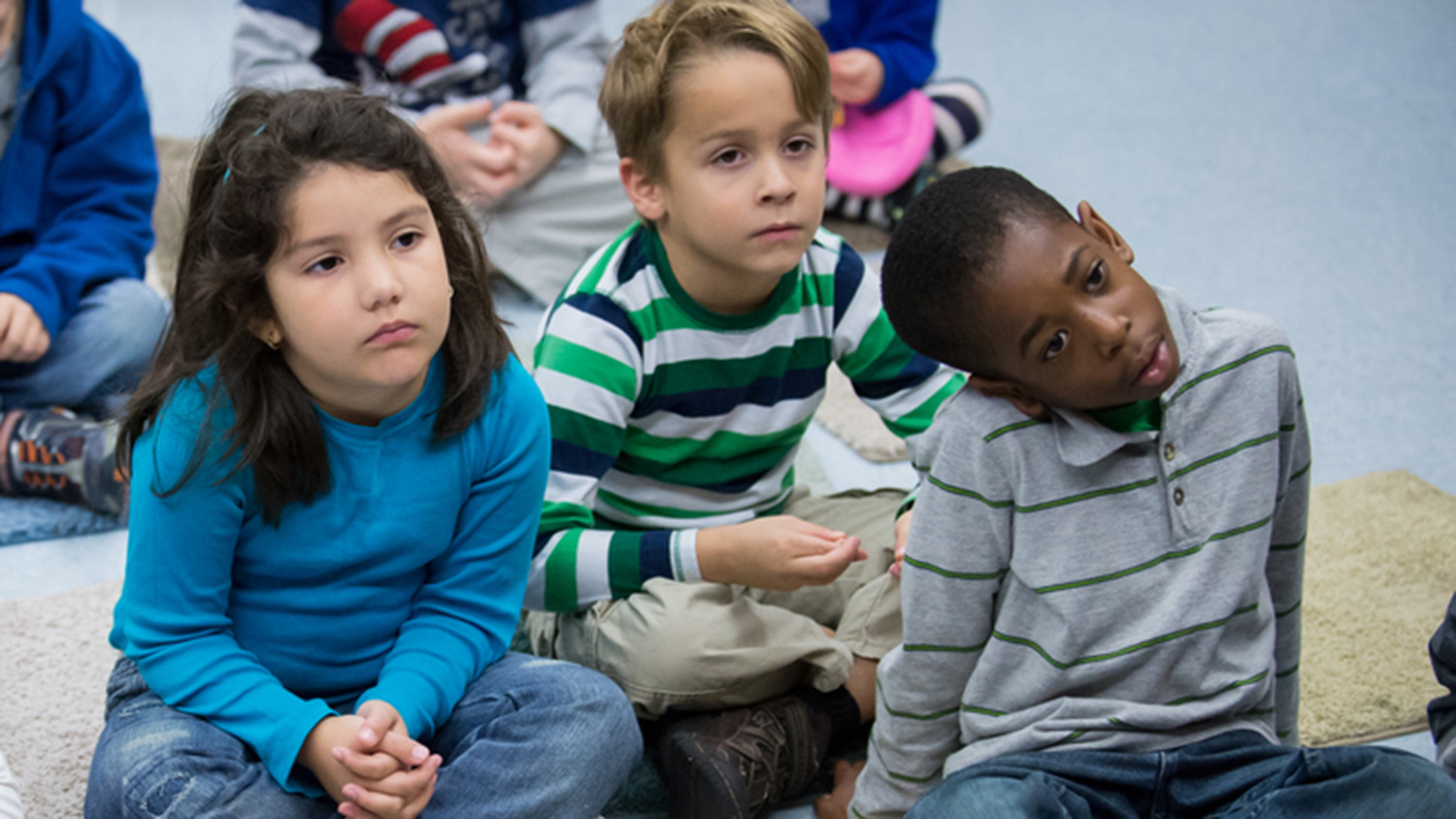 Three children in a classroom.