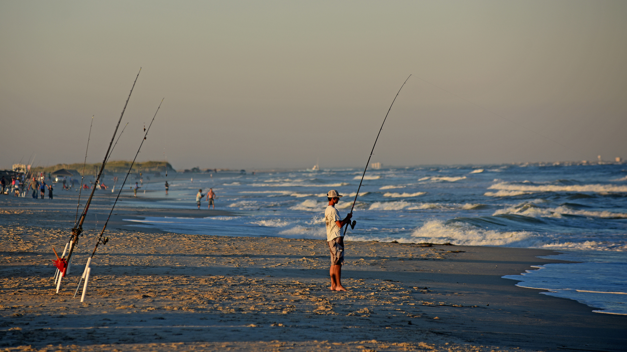 Fisherman tries his luck along the surf at Carolina Beach's Freeman Park.