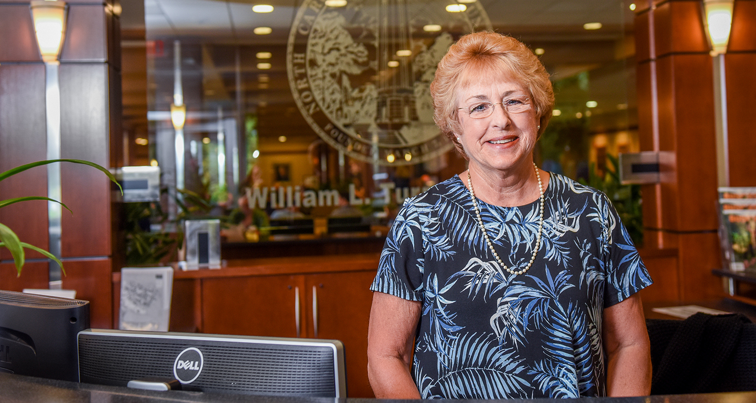 Alice Warren behind the main desk in the McKimmon Center.