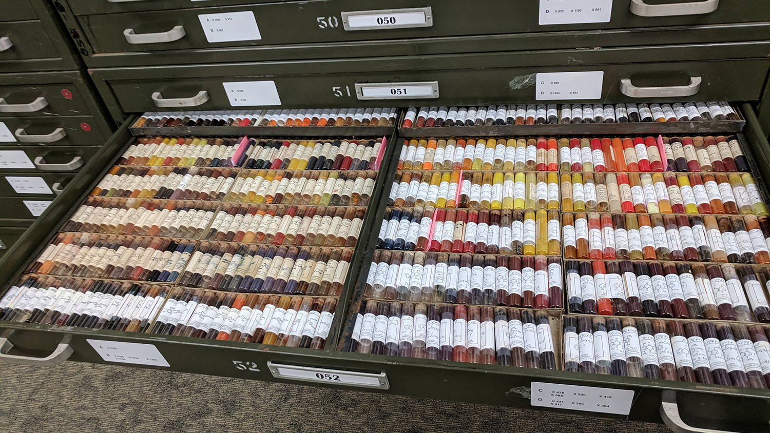 Photo of a drawer containing vials of dyes.