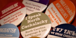 Colorful buttons sport phrases such as "I speak North Cackalacky" and "dingbatter" -- slang phrases from traditional state dialects.