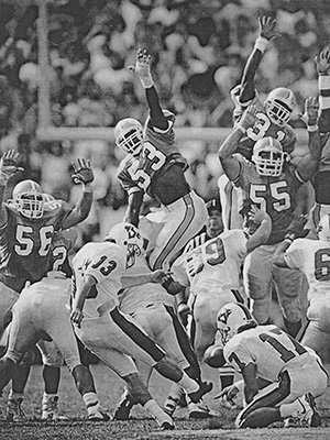 Carolina players attempt to block field goal.