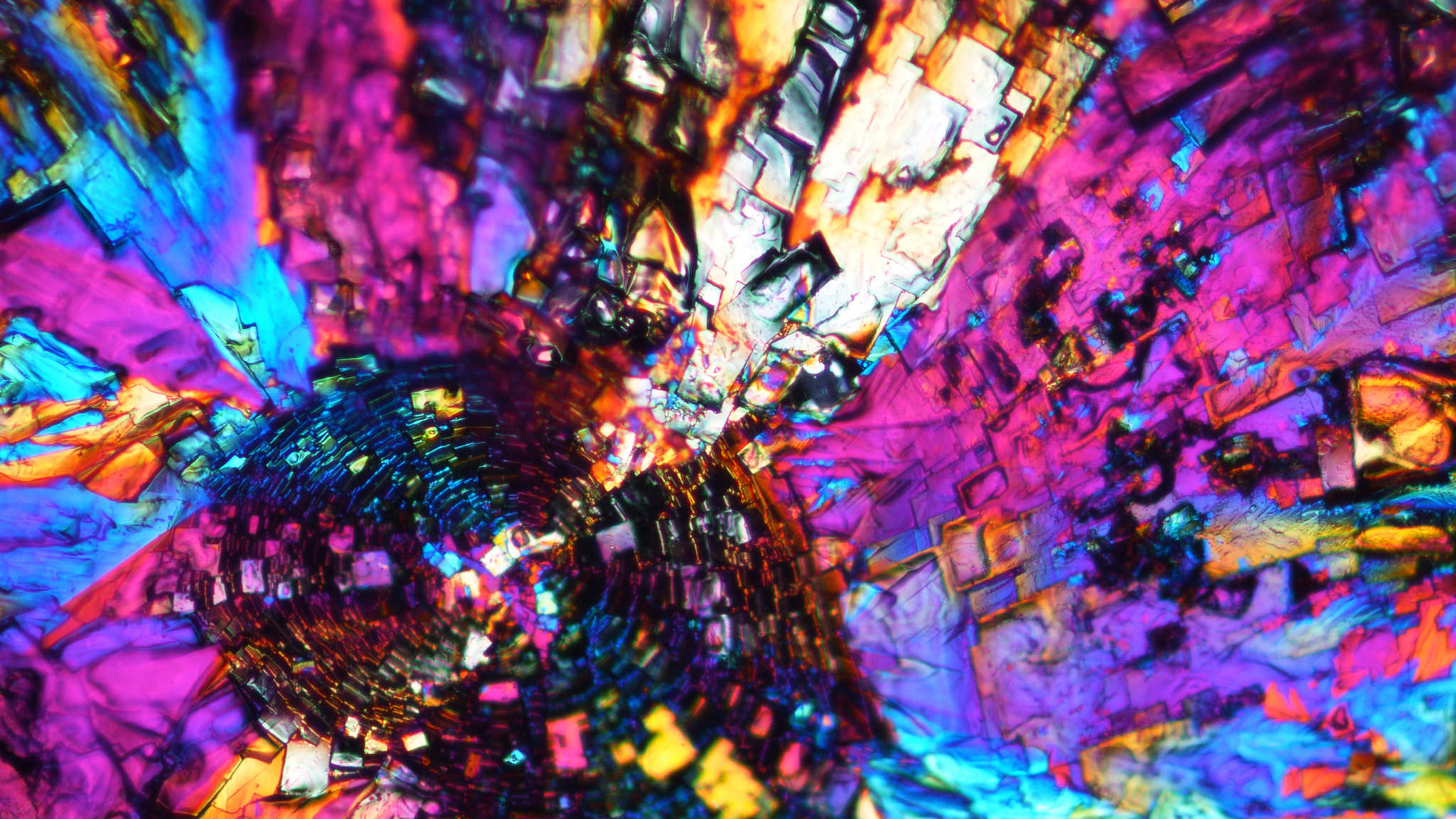 An unedited polarized light microscope image shows the crystal formation of a special type polyhedral oligomeric silsesquioxane (POSS) solvent-casted with chloroform.